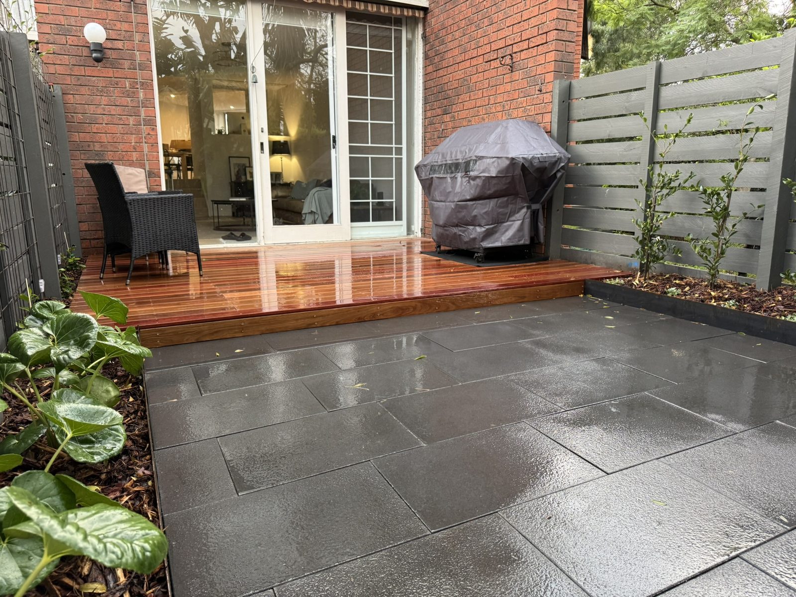 Kew — charcoal paved terrace beside the Ironbark deck